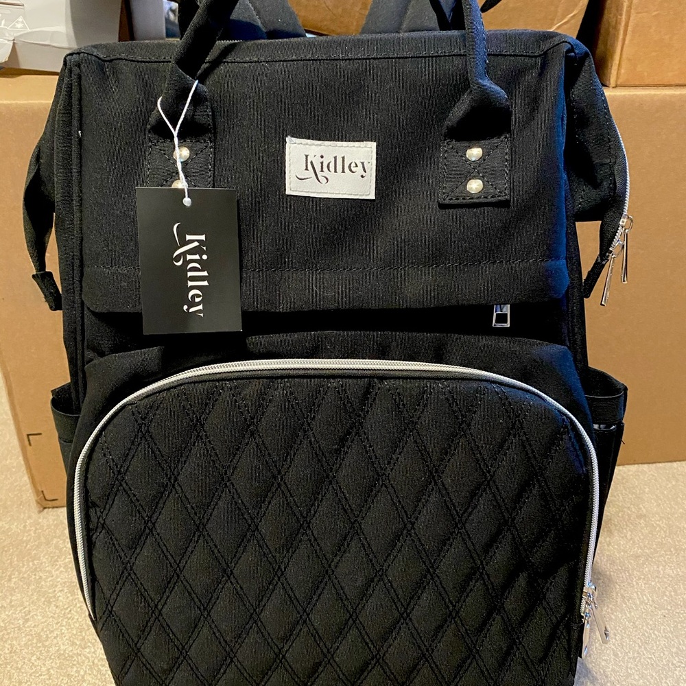 Diaper Bag Backpack includes hidden pull out seat